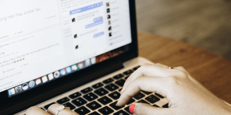 A woman typing on a computer.